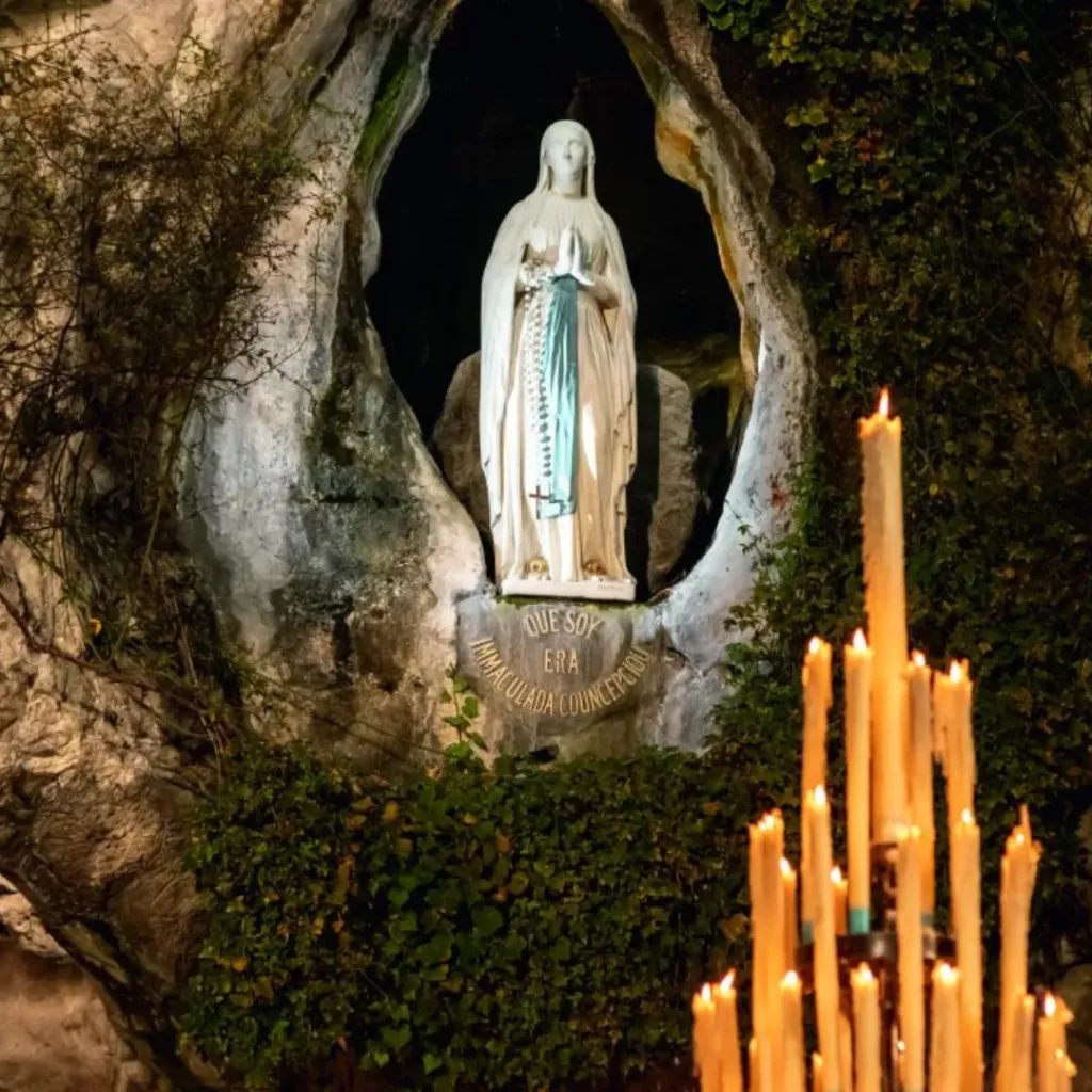 Placing a petition at the Grotto of Lourdes